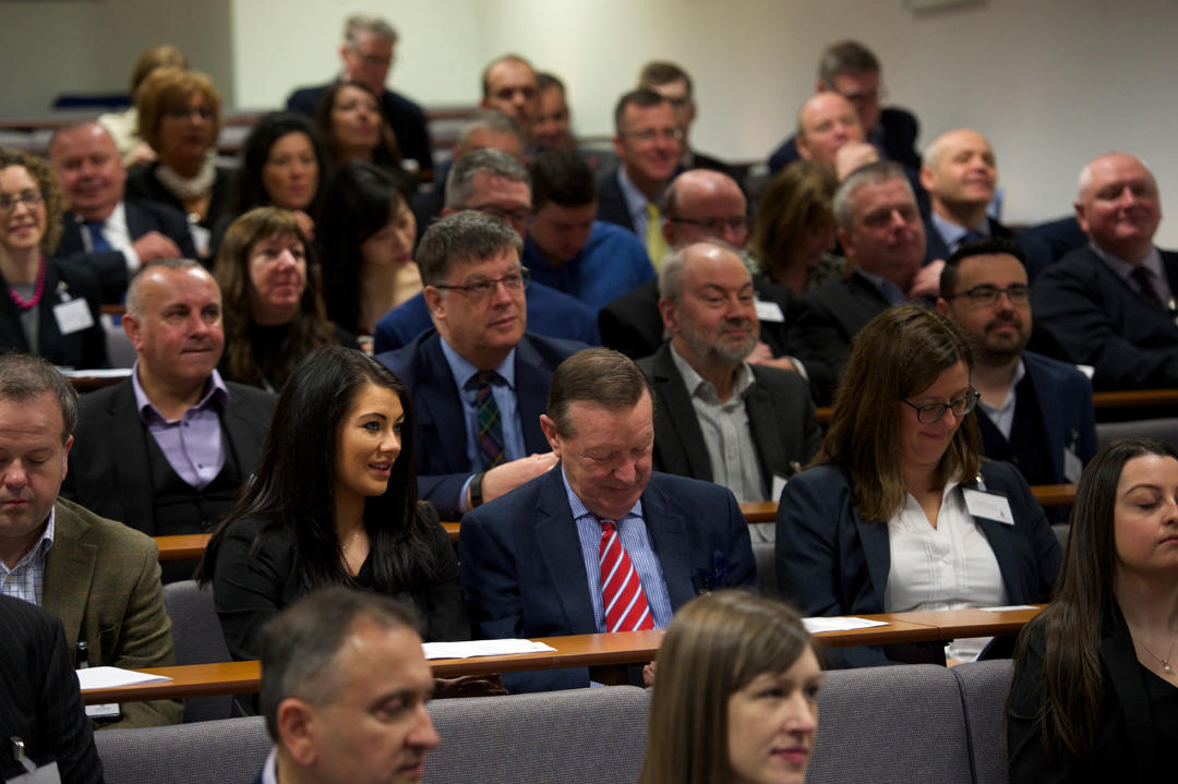 Image of a group of professionals sitting at a training event